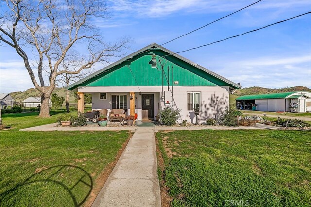 view of front of property with a front yard and a porch