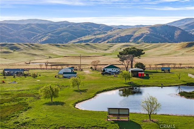 view of mountain feature with a rural view and a water view