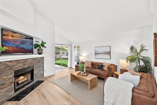 living room with high vaulted ceiling, light hardwood / wood-style flooring, a stone fireplace, and crown molding