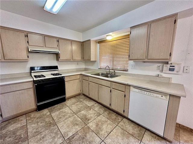 kitchen featuring black range with gas stovetop, sink, white dishwasher, and light brown cabinetry