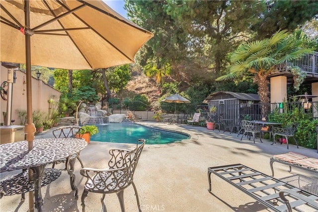 view of swimming pool featuring pool water feature and a patio area