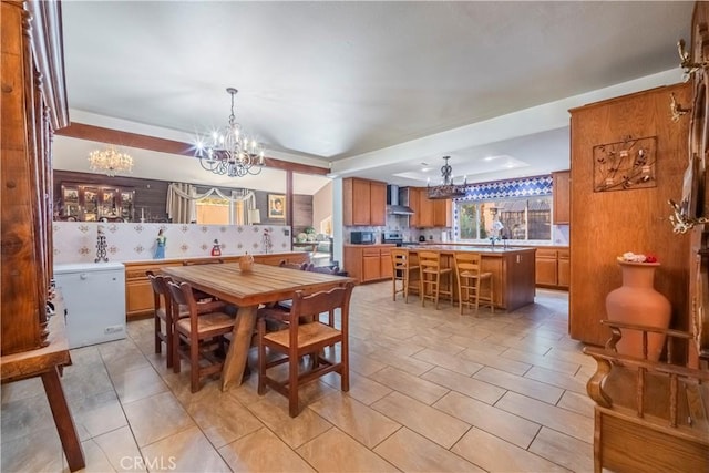 dining space featuring a notable chandelier and sink