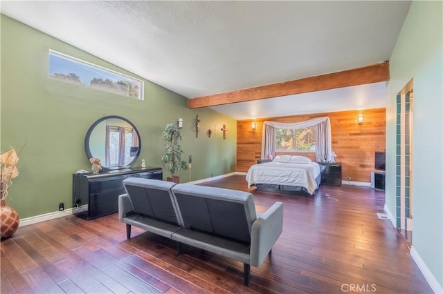 bedroom featuring wood walls, lofted ceiling with beams, and dark hardwood / wood-style floors