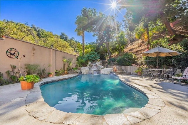 view of pool with a patio area and pool water feature