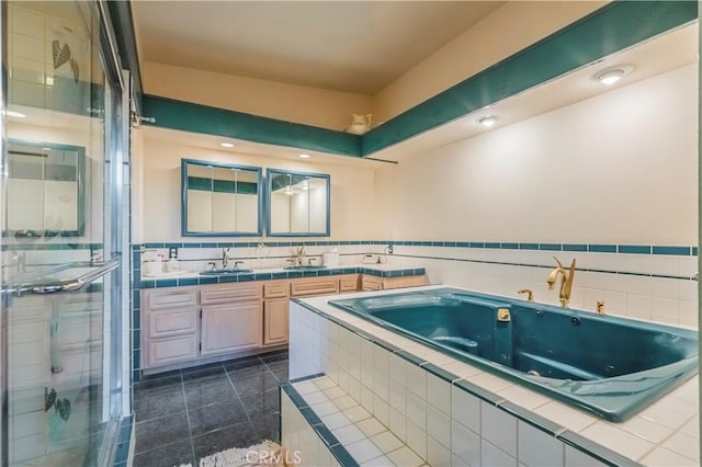 bathroom featuring tile patterned flooring, shower with separate bathtub, and vanity