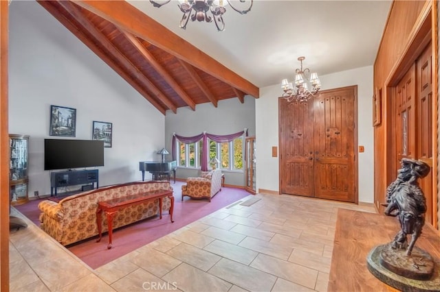 tiled foyer entrance featuring vaulted ceiling with beams and a notable chandelier