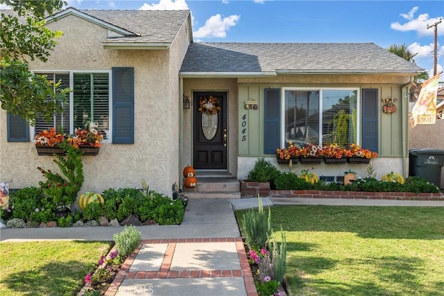 view of exterior entry with a lawn