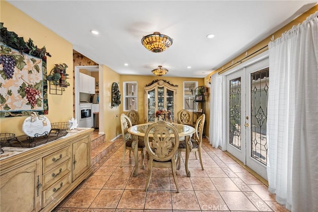 dining area with french doors and light tile patterned floors