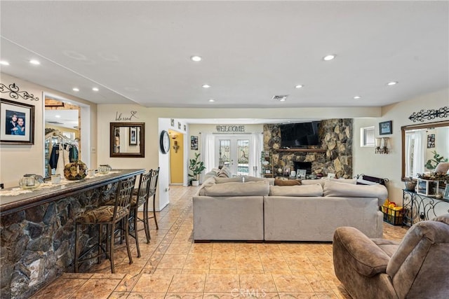 living room with a fireplace and french doors