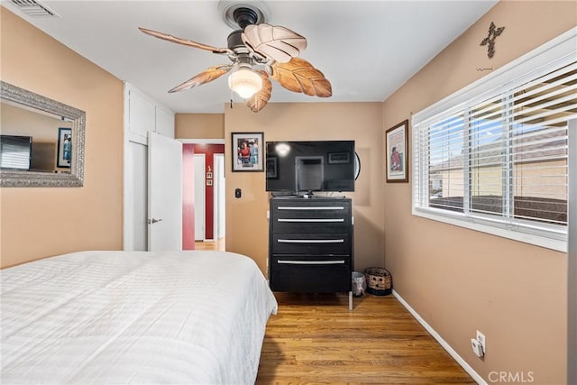 bedroom with ceiling fan and light hardwood / wood-style floors