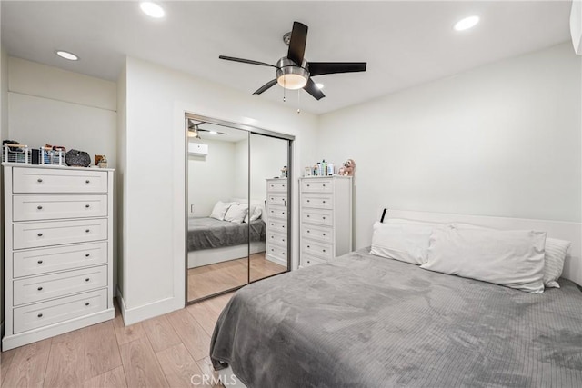 bedroom with ceiling fan, a closet, and light hardwood / wood-style flooring