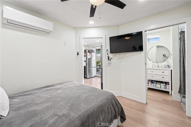 bedroom featuring an AC wall unit, multiple windows, ceiling fan, and light hardwood / wood-style flooring