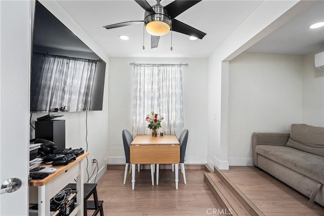 dining area with ceiling fan and wood-type flooring