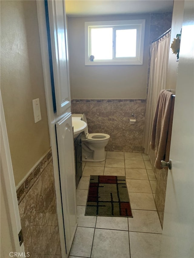 bathroom with tile patterned floors, vanity, and tile walls