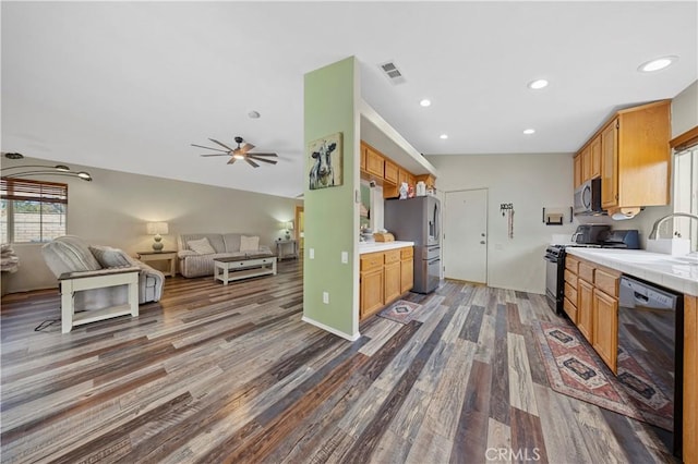 kitchen with vaulted ceiling, ceiling fan, dark wood-type flooring, sink, and black appliances