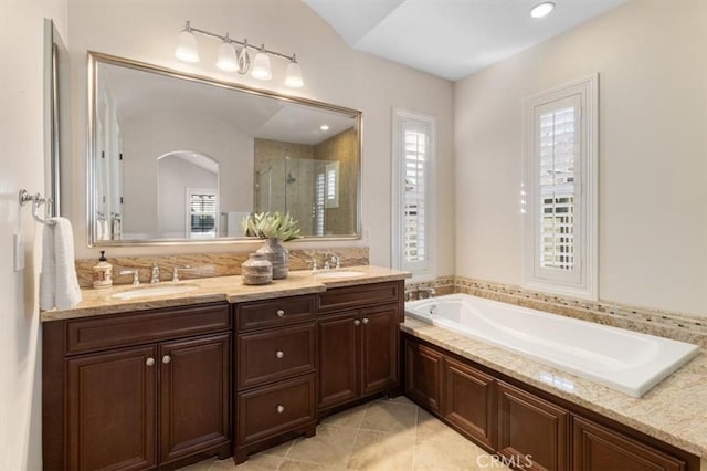 bathroom with shower with separate bathtub, vanity, and tile patterned floors