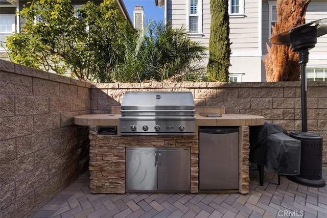 view of patio with an outdoor kitchen and area for grilling