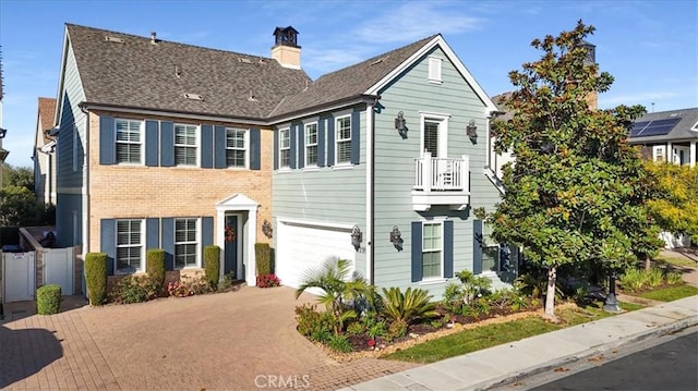 view of front of house with a garage and a balcony