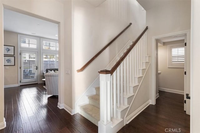 stairway featuring wood-type flooring