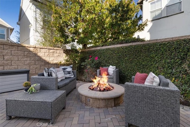 view of patio / terrace with an outdoor living space with a fire pit