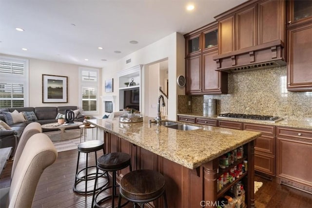 kitchen with a healthy amount of sunlight, dark hardwood / wood-style flooring, sink, and stainless steel gas cooktop