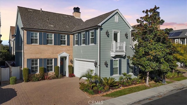 view of front facade featuring a balcony and a garage