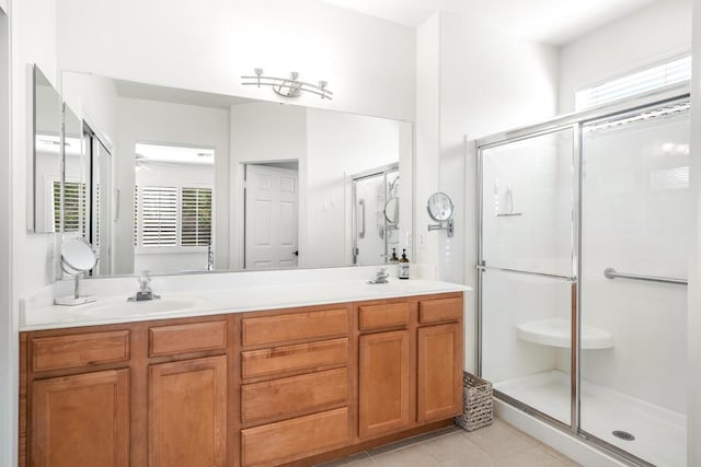 bathroom with tile patterned flooring, vanity, and a shower with shower door