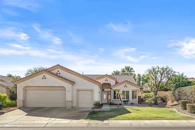 mediterranean / spanish-style home featuring a front yard and a garage