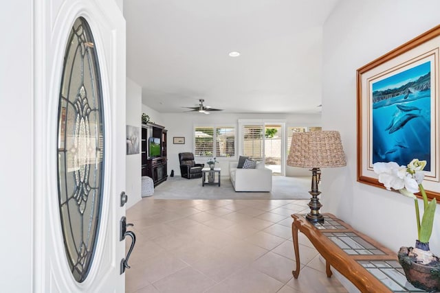 entryway with ceiling fan and light tile patterned flooring