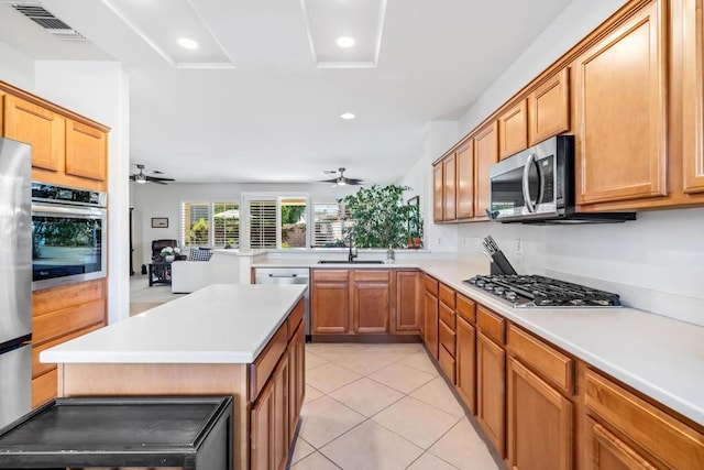 kitchen featuring ceiling fan, sink, light tile patterned floors, and appliances with stainless steel finishes