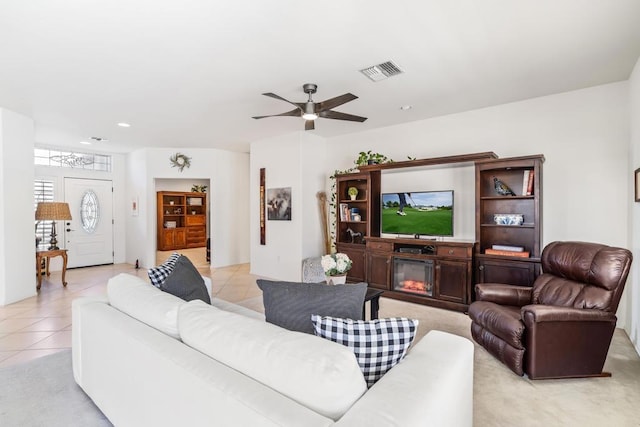 tiled living room featuring ceiling fan