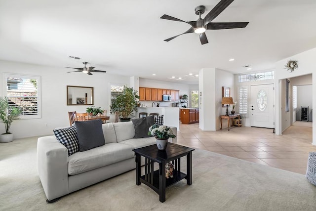 tiled living room featuring ceiling fan