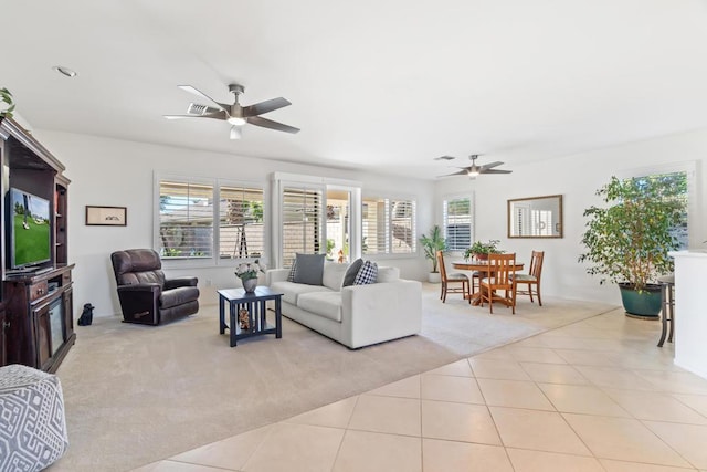 living room with ceiling fan, a healthy amount of sunlight, and light tile patterned floors