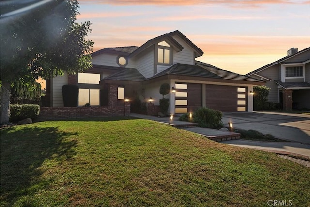 view of front facade with a garage and a yard