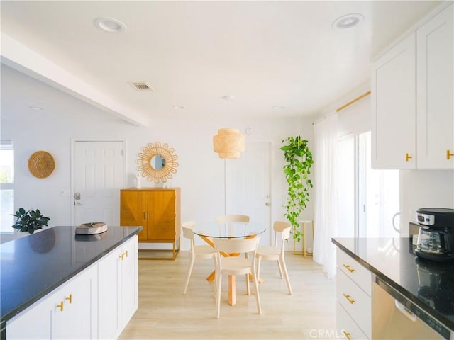 kitchen featuring dishwasher, light hardwood / wood-style floors, and white cabinetry