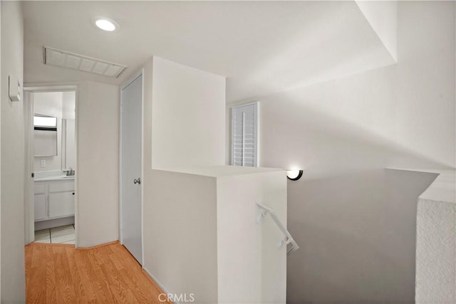 hall featuring sink and light hardwood / wood-style floors