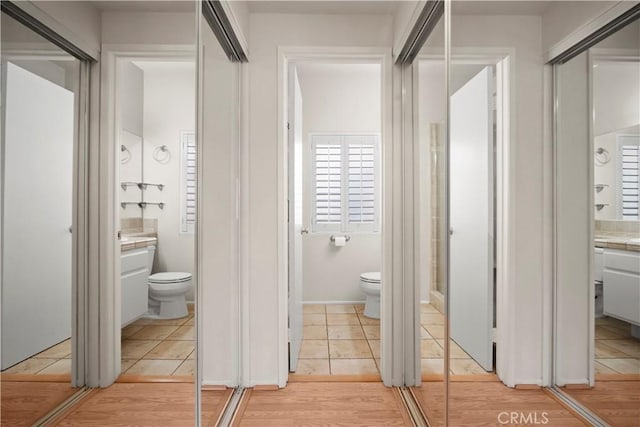 bathroom with hardwood / wood-style flooring and toilet