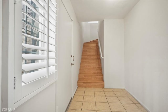 stairway featuring tile patterned flooring