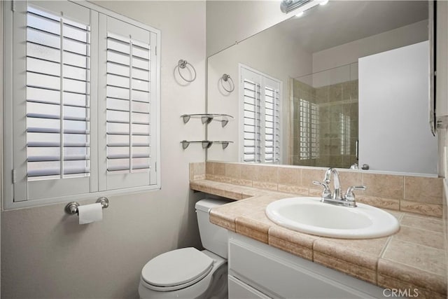 bathroom with plenty of natural light, a shower with door, and toilet