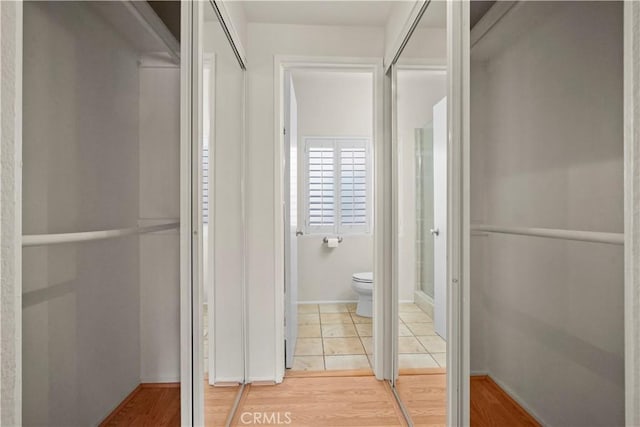 bathroom featuring wood-type flooring and toilet