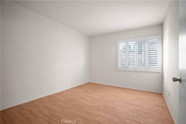 spare room with light wood-type flooring