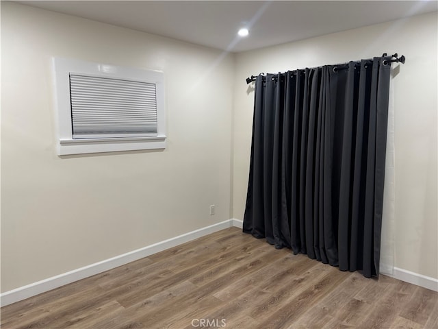 spare room featuring wood-type flooring