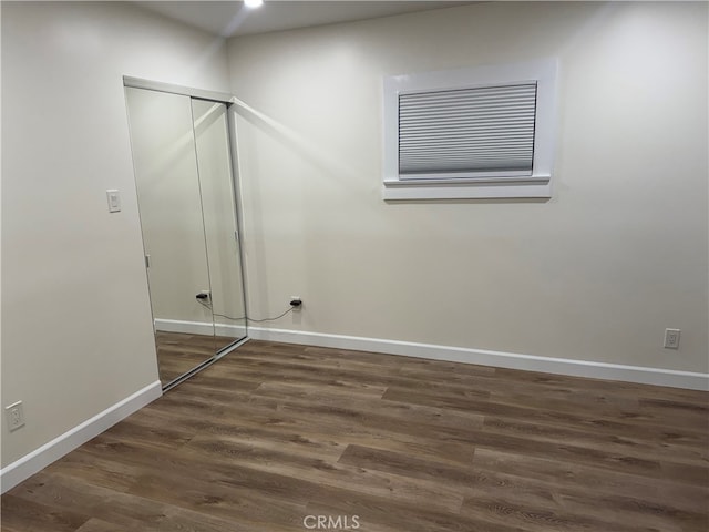 empty room featuring dark wood-type flooring