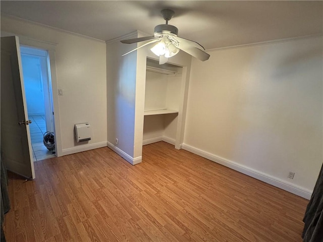 unfurnished bedroom featuring ceiling fan, a closet, ornamental molding, and light hardwood / wood-style flooring