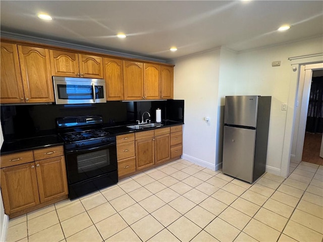 kitchen with tasteful backsplash, sink, light tile patterned flooring, and appliances with stainless steel finishes