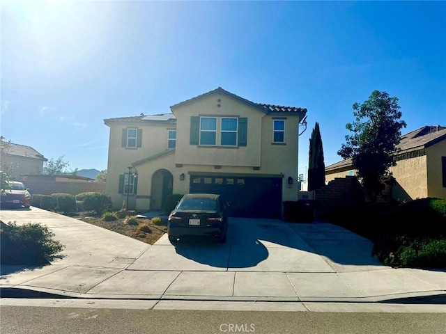 mediterranean / spanish-style home with a garage