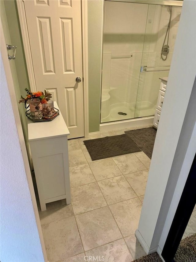 bathroom featuring tile patterned flooring and a shower with door