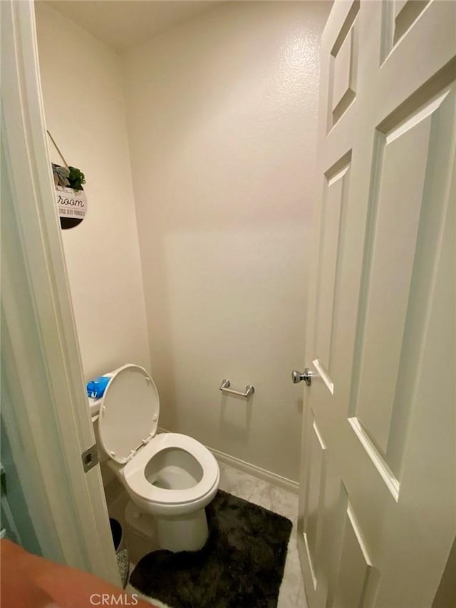 bathroom with tile patterned floors and toilet