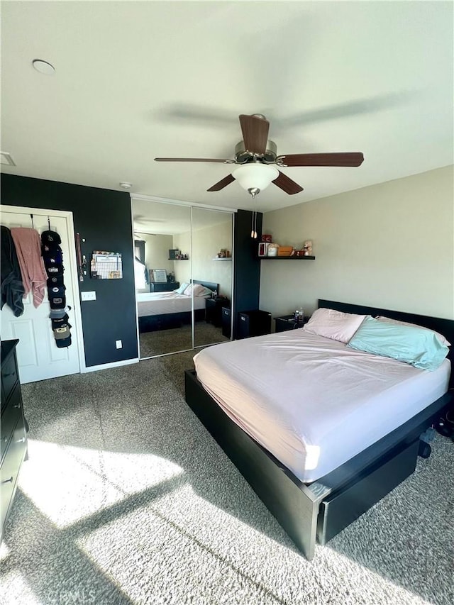 carpeted bedroom with ceiling fan and a closet