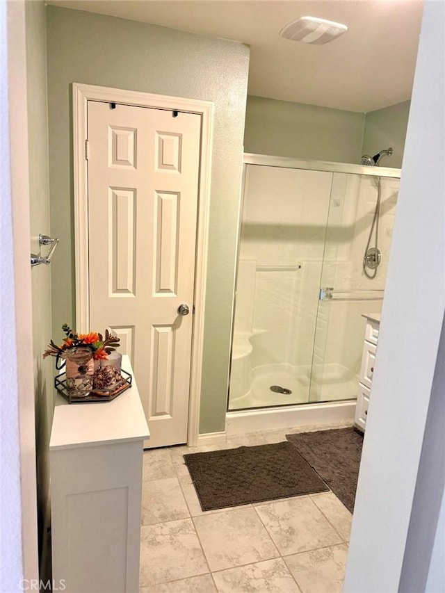 bathroom with a shower with door